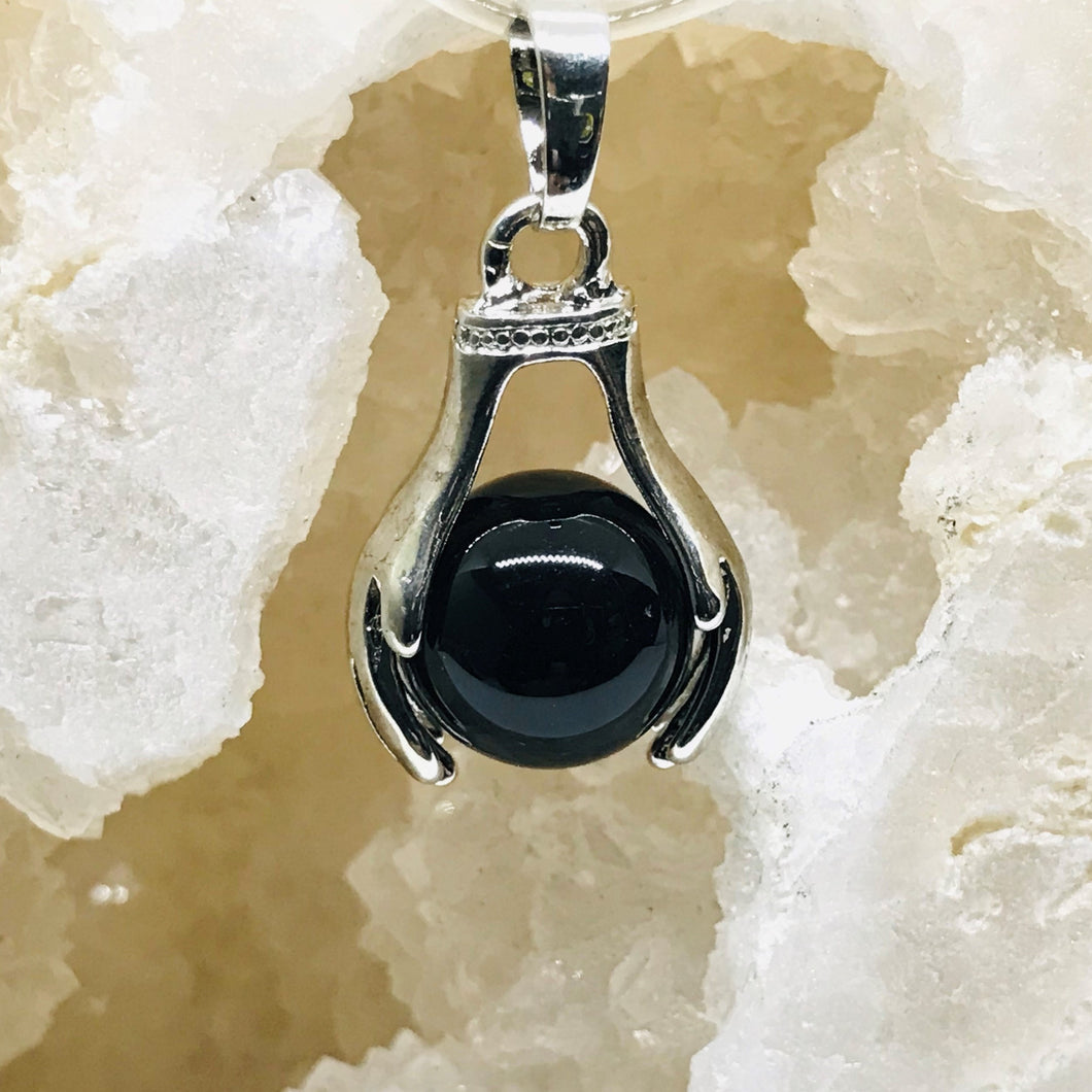 COLGANTE DE PIEDRA | ESFERA CON MANOS | ONIX